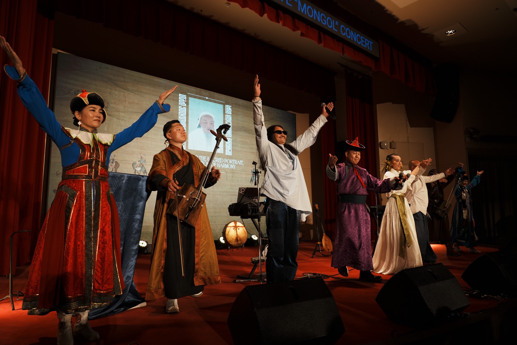 Performers in traditional dress on stage during the commemorative concert